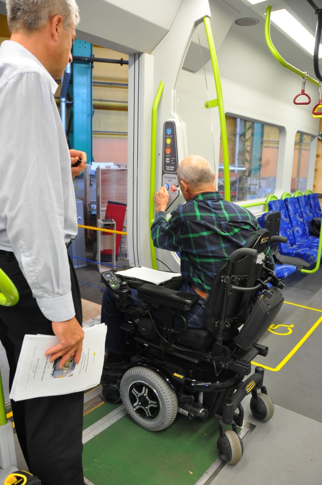 a man in a wheelchair open the train door