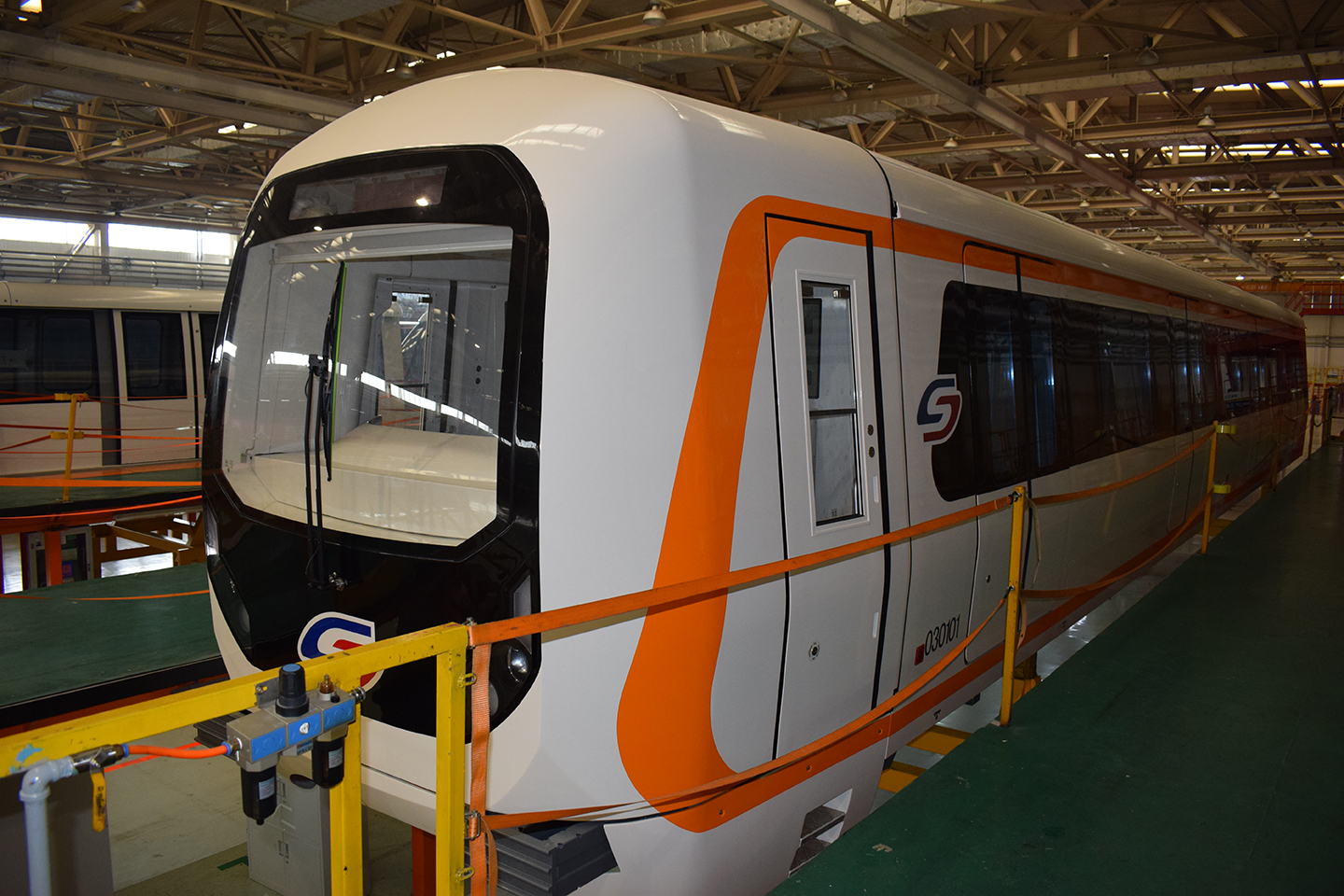 white and orange train in the building facility